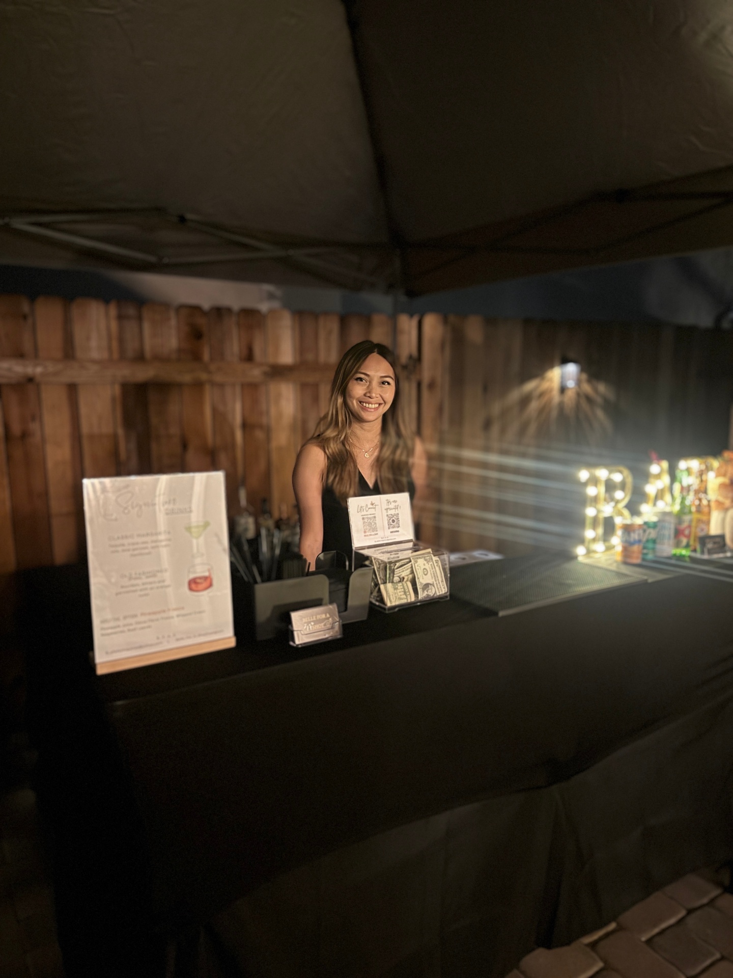 Bartender pouring a cocktail at sunset